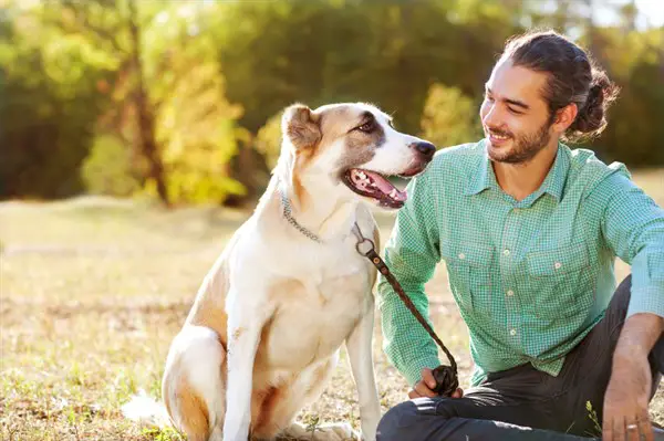 man and dog in a park